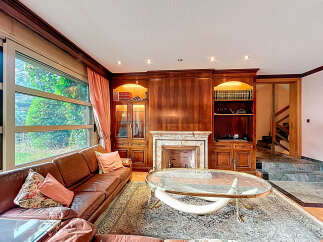 Elegant living room with a cozy fireplace and built-in bookshelves.