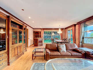 Elegant living space featuring a luxurious leather sofa and a stunning glass coffee table.
