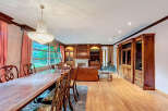 Elegant dining room with a stunning chandelier and a large wooden dining table.