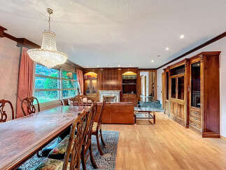 Elegant dining room with a stunning chandelier and a large wooden dining table.
