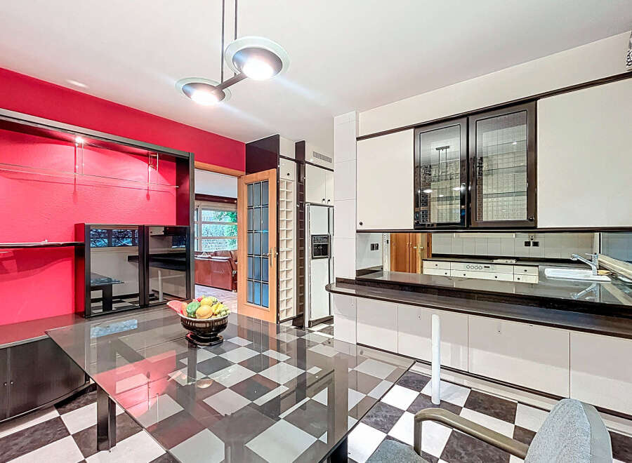 Step into a stunning kitchen with a unique black and white checkered floor.