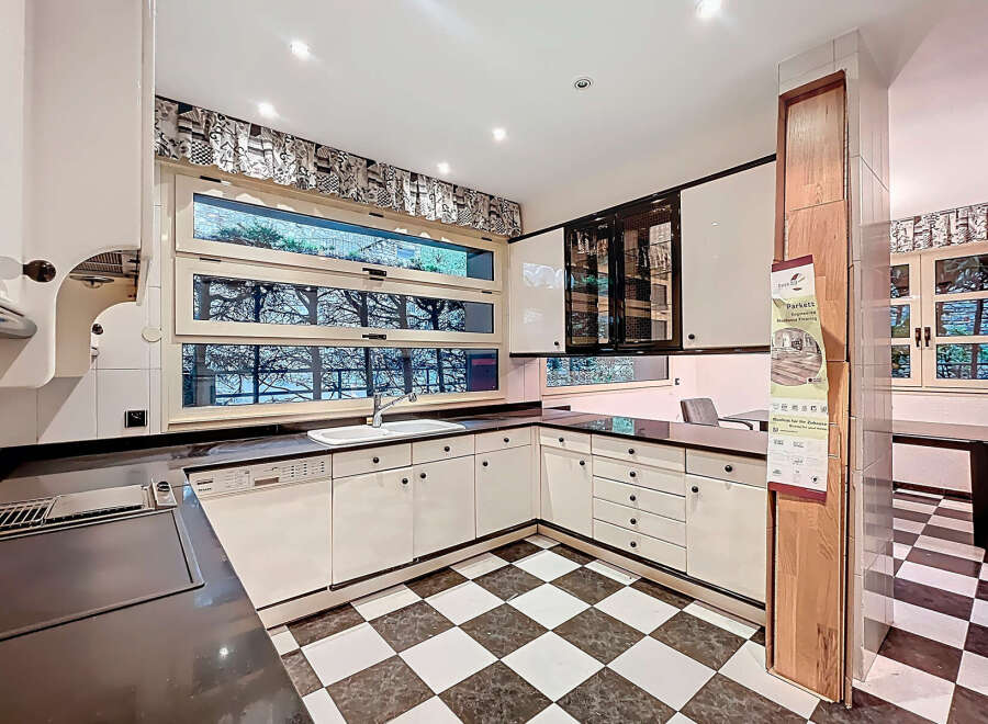 Step into this stunning kitchen, featuring sleek white cabinetry and a modern design.