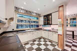 Step into this stunning kitchen, featuring sleek white cabinetry and a modern design.