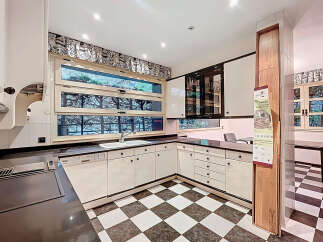 Step into this stunning kitchen, featuring sleek white cabinetry and a modern design.