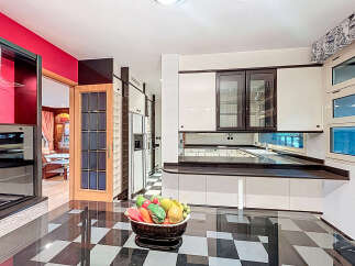 Step into this stunning kitchen, featuring a sleek black and white checkered floor that adds a touch of modern elegance.