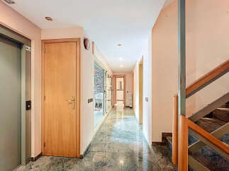 Discover a beautifully designed hallway with a modern elevator and elegant wooden doors.