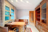 Elegant home office featuring a classic wooden desk and matching chairs, perfect for productivity.