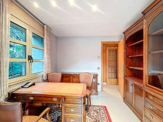Elegant home office featuring a classic wooden desk and matching chairs, perfect for productivity.