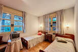 Cozy bedroom with two single beds, perfect for a relaxing stay.