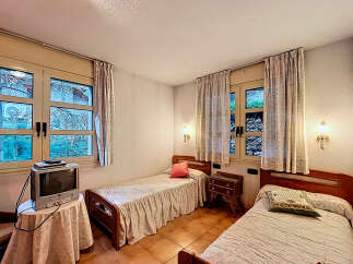 Cozy bedroom with two single beds, perfect for a relaxing stay.
