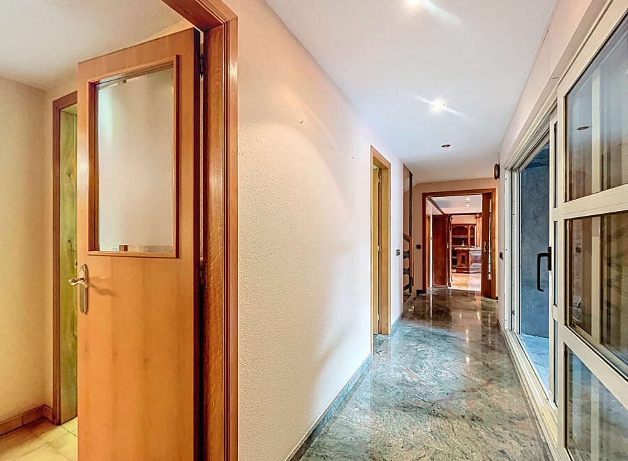 Explore this stunning property featuring a bright and airy hallway with elegant marble flooring.