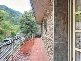 Discover a charming property with a stunning balcony overlooking a picturesque mountain view.