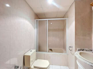 This bathroom features a clean and modern design with neutral-colored tiles.