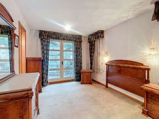 Elegant bedroom with classic wooden furniture.