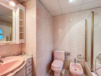 Step into this charming bathroom featuring a unique pink color scheme.