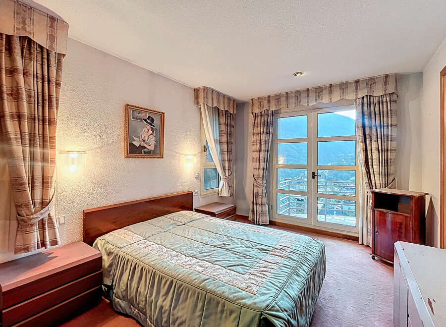 Cozy bedroom with a comfortable bed and elegant curtains.