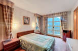 Cozy bedroom with a comfortable bed and elegant curtains.