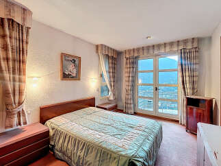 Cozy bedroom with a comfortable bed and elegant curtains.