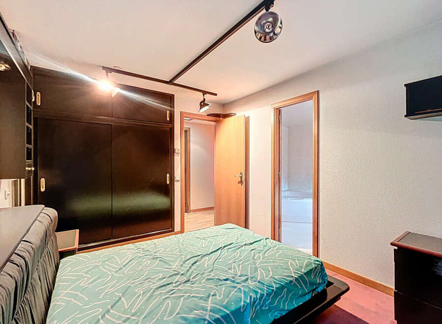 Discover this inviting bedroom featuring a stylish bed and a spacious wardrobe.