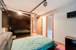 Discover this inviting bedroom featuring a stylish bed and a spacious wardrobe.