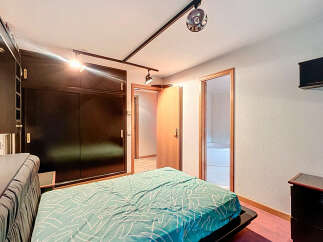 Discover this inviting bedroom featuring a stylish bed and a spacious wardrobe.