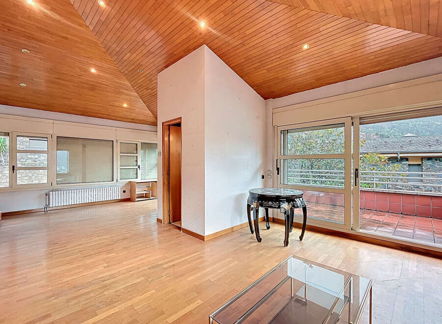 Discover this stunning property featuring a unique wooden ceiling and expansive windows that flood the space with natural light.