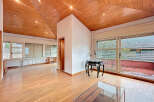 Discover this stunning property featuring a unique wooden ceiling and expansive windows that flood the space with natural light.