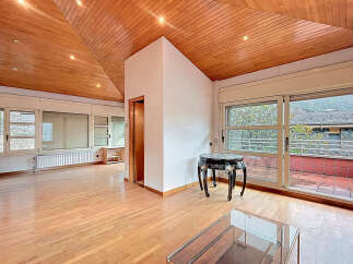 Discover this stunning property featuring a unique wooden ceiling and expansive windows that flood the space with natural light.