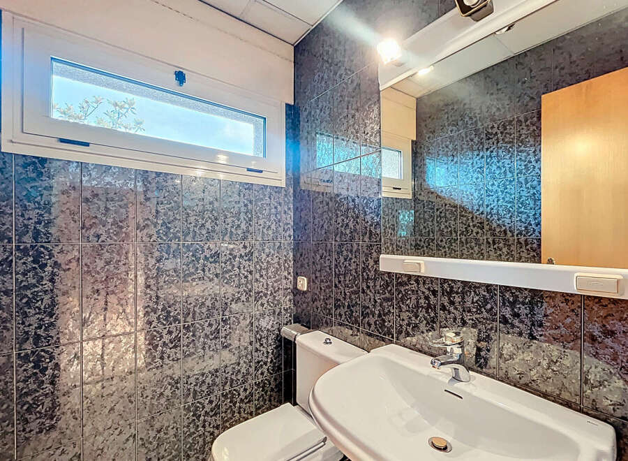 Discover a stylish bathroom featuring a modern sink and a sleek toilet.