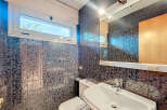 Discover a stylish bathroom featuring a modern sink and a sleek toilet.