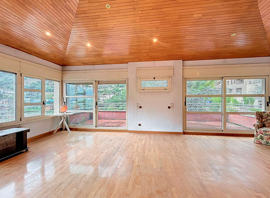 Discover this stunning property featuring a unique wooden ceiling and expansive windows that flood the space with natural light.