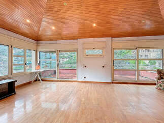 Discover this stunning property featuring a unique wooden ceiling and expansive windows that flood the space with natural light.