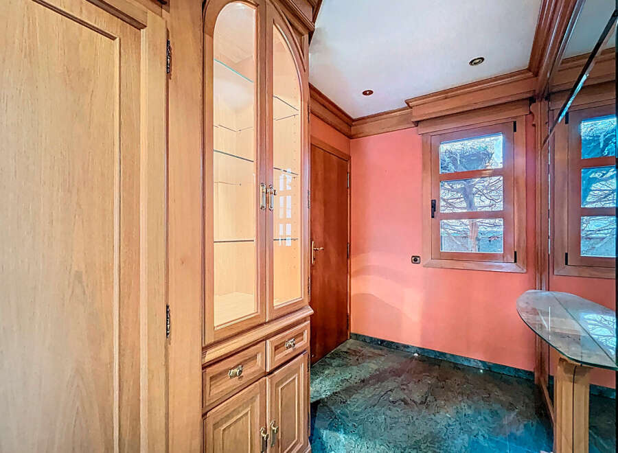 Discover the charm of this property, featuring elegant wooden cabinetry and a stylish display cabinet.