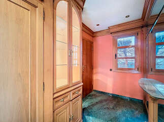 Discover the charm of this property, featuring elegant wooden cabinetry and a stylish display cabinet.