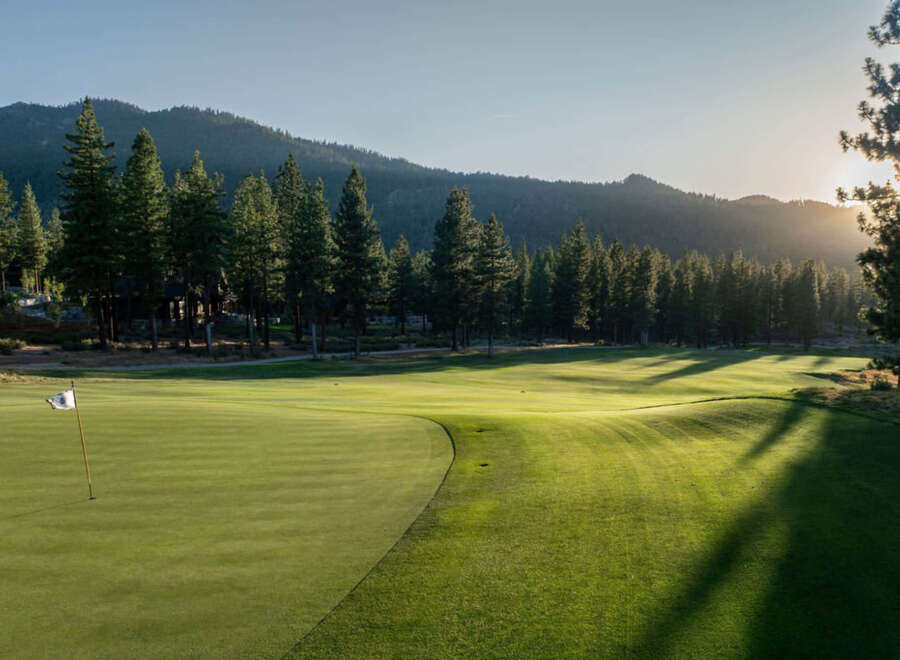 Nestled within a verdant landscape, this pristine golf course offers an idyllic retreat for luxury homeowners.