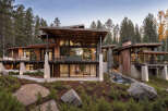 This modern mountain home boasts expansive windows, a private balcony, and a serene waterfall feature.