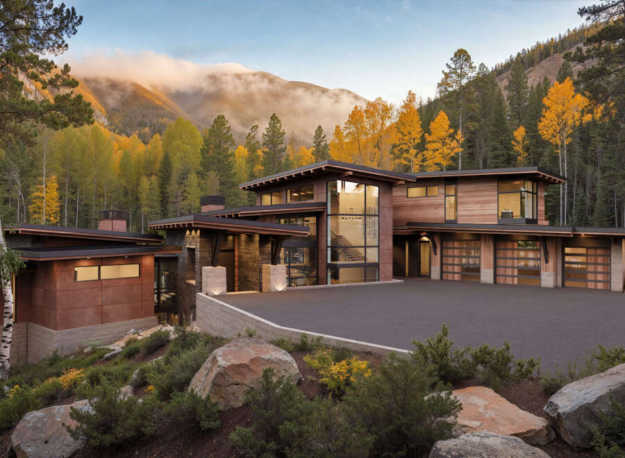 This modern mountain home features stunning natural wood exteriors and expansive windows to capture breathtaking views.