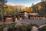 This modern mountain home features stunning natural wood exteriors and expansive windows to capture breathtaking views.