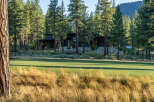 Nestled amidst towering trees and overlooking a pristine golf course, this modern home offers a serene escape.