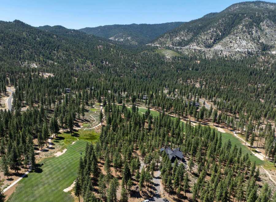 Nestled among towering pines, this luxury property offers privacy and stunning views.