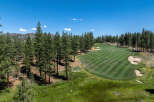 Discover luxury living with golf course frontage! This stunning view showcases the lush green fairway surrounded by towering pines.