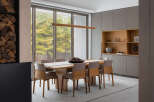 This stunning dining room boasts a sleek, modern design with floor-to-ceiling windows offering breathtaking views of the surrounding landscape.