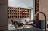 This stunning living room boasts a built-in wooden bookcase filled with books and media, creating a warm and inviting atmosphere.