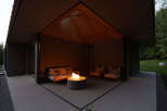 This modern home features a stunning outdoor patio with a built-in fire pit, perfect for relaxing evenings.