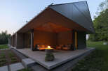 This modern home features a stunning outdoor patio area complete with a fire pit, perfect for relaxing evenings.