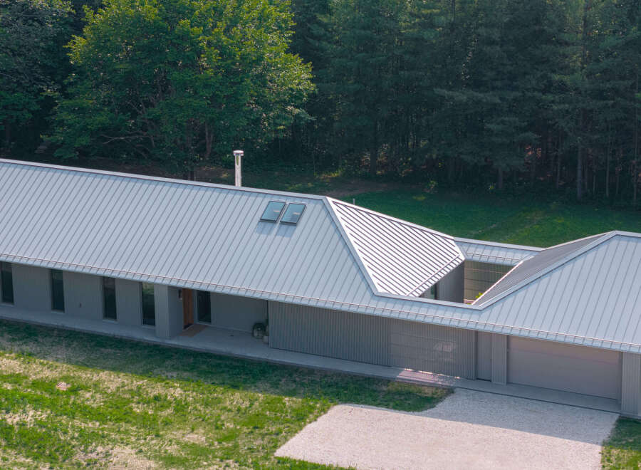 This modern home boasts a sleek, contemporary design with a striking metal roof.