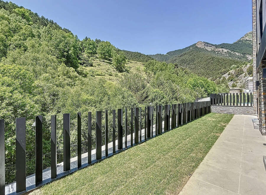 Enjoy the tranquility of this property with its well-maintained lawn and modern fence, offering privacy and a seamless blend with nature.