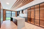 This contemporary kitchen boasts a spacious island with a unique marble countertop, providing ample space for food preparation and casual dining.