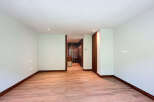 This is a bright and airy room with beautiful wood flooring and natural light.
