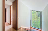 This property boasts natural light through its expansive window, complemented by warm wooden accents and modern lighting.